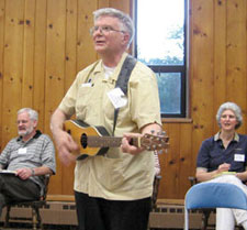 Father D. Brude Nieli, C.S.P., sings and plays the guitar during the Paulist 150th Anniversary Holy Spirit Retreat held at Mount Paul in Oak Ridge, N.J., in June 2007. Father Nieli was a member of the "Roamin' Collars," a group of seminarians that roamed across college campuses bringing the Gospel message of love and hope to young people. These folk singers sought integrate Christian themes with contemporary American styles of music.