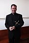 Thomas C. Gibbons stands with his Paulist Mission Cross. (Photo credit: Bruce Byers, brucebyers.com)