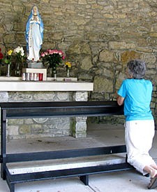 A Paulist Associate takes time for personal reflection at the grotto on the grounds of the St. Therese Retreat Center