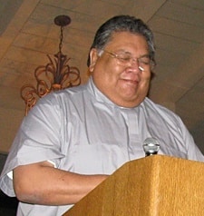 Father Ruben Patino, CSP, pastor of St. Paul the Apostle Chapel in Horseshoe Bay, leads grace during the gala awards dinner of the Paulist Open at the Horseshoe Bay Yacht Club.