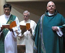 Deacon Simon Tsui (left) and Father Daniel McCotter, CSP, pastor of Holy Family Chinese Mission in San Francisco, greet the congregation gathered at Old St. Mary's Cathedral in San Francisco Aug. 30 for a joint Chinese-English Mass.