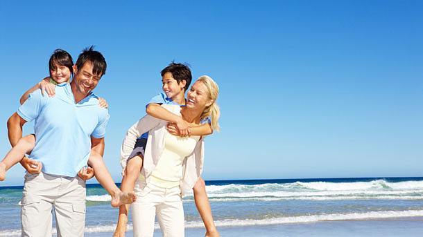A family frolicks on a sunkissed beach. Father Michael B. McGarry, president of the Paulist Fathers, points out how deadlines can launch us out of summertime procrastination and into a richer, deeper spiritual life.