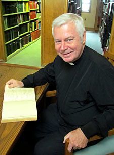 Paulist historian Father Paul G. Robichaud reads the spiritual notebook of Paulist Founder Father Isaac T. Hecker in the library of St. Paul's College in Washington, D.C.