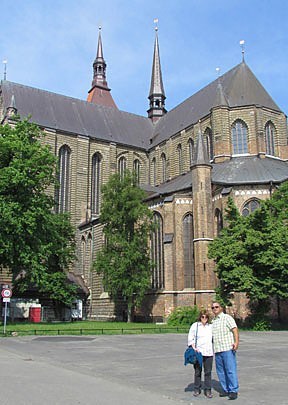 Mike and Kathleen Lossau of Buda, Tex., pose outside of Holy Cross Abbey in Rostock, Germany during Paulist Pilgrimage 2012.