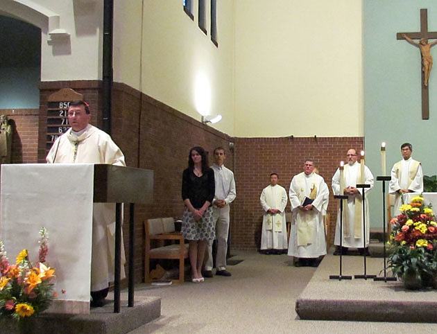 Bishop Lee Piche of the Archdiocese of St. Paul and Minneapolis proclaims the Gospel during the 125th anniversary Mass at St. Lawrence Church and Newman Center in Minneapolis Nov. 3.
