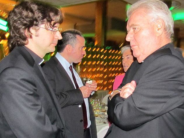  Father John Duffy, CSP , vice-rector of Santa Susanna (right), chats with a guest at the St. Nicholas Charity Serata in Rome Dec. 1