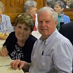 Pilgrims Maureen and Robert St. Jean (from left) and Elsa Lenches await dinner on their last night in Rome.