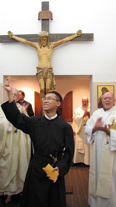 Jimmy Hsu beams as he holds up a newly-minted 2013 penny, the payment for a lifetime of service with the Paulist Fathers. Mr. Hsu made his final promise with the Paulists Sept. 6 at St. Paul's College.