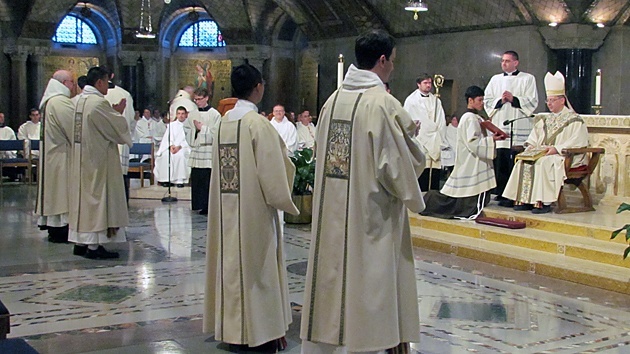 Four newly ordained and vested deacons stand before altar of the Crypt Church of the Basilica of the National Shrine of the Immaculate Conception in Washington, D.C. Paulist Jimmy Hsu stands second from right.