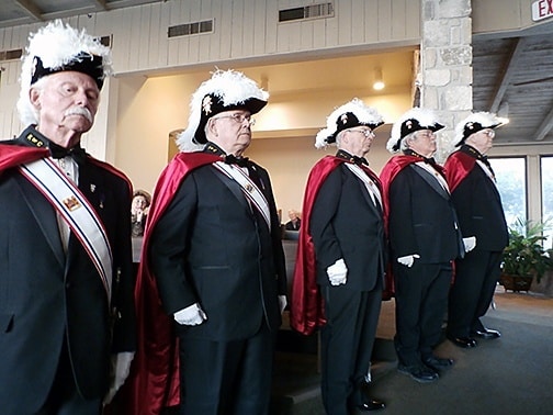 The Knights of Columbus of St. Paul the Apostle Parish in Horseshoe Bay, Texas, stand at attention during the entrance procession of the Mass dedicating the new altar and family life center at the church.