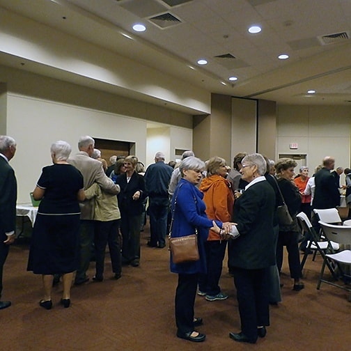 Parishioners of St. Paul the Apostle mix and mingle in the new Linda Finn Family Life Center.