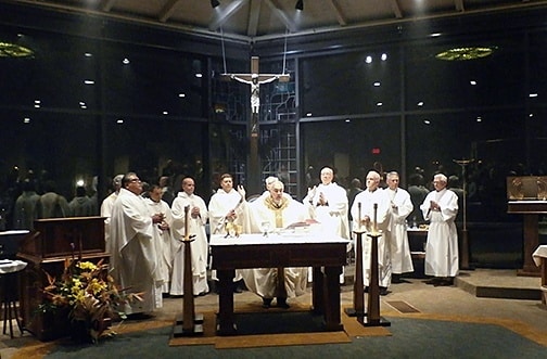 Four Paulist priests and guests concelebrate the Liturgy of the Eucharist with Bishop Joe S. Vásquez.
