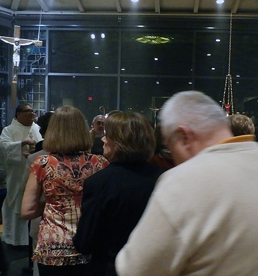 A jubilant Father Ruben Patiño, CSP, offers Holy Communion.