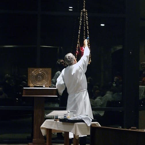The candle that shows the Body of Christ is present in the new tabernacle is lit for the first time at St. Paul the Apostle in Horseshoe Bay.