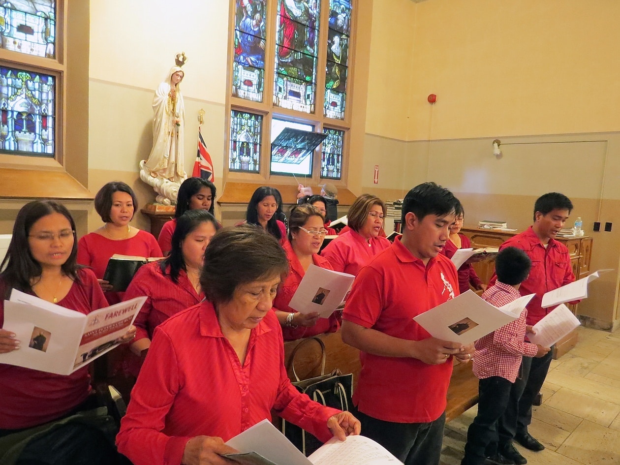 The Filipino Choir and Music Group at St. Peter’s leads the processional hymn.
