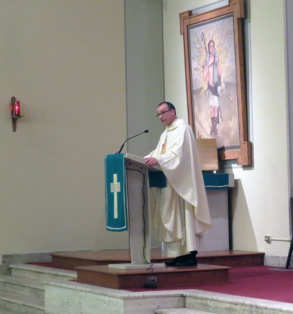 Father Eric Andrews, president of the Paulist Fathers, preaches the Gospel.