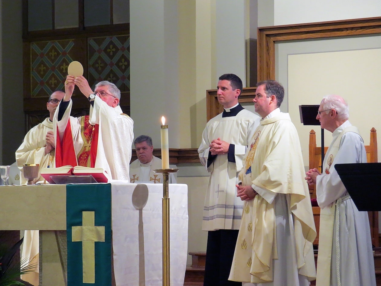  Cardinal Thomas Collins of Toronto holds up the Eucharist.