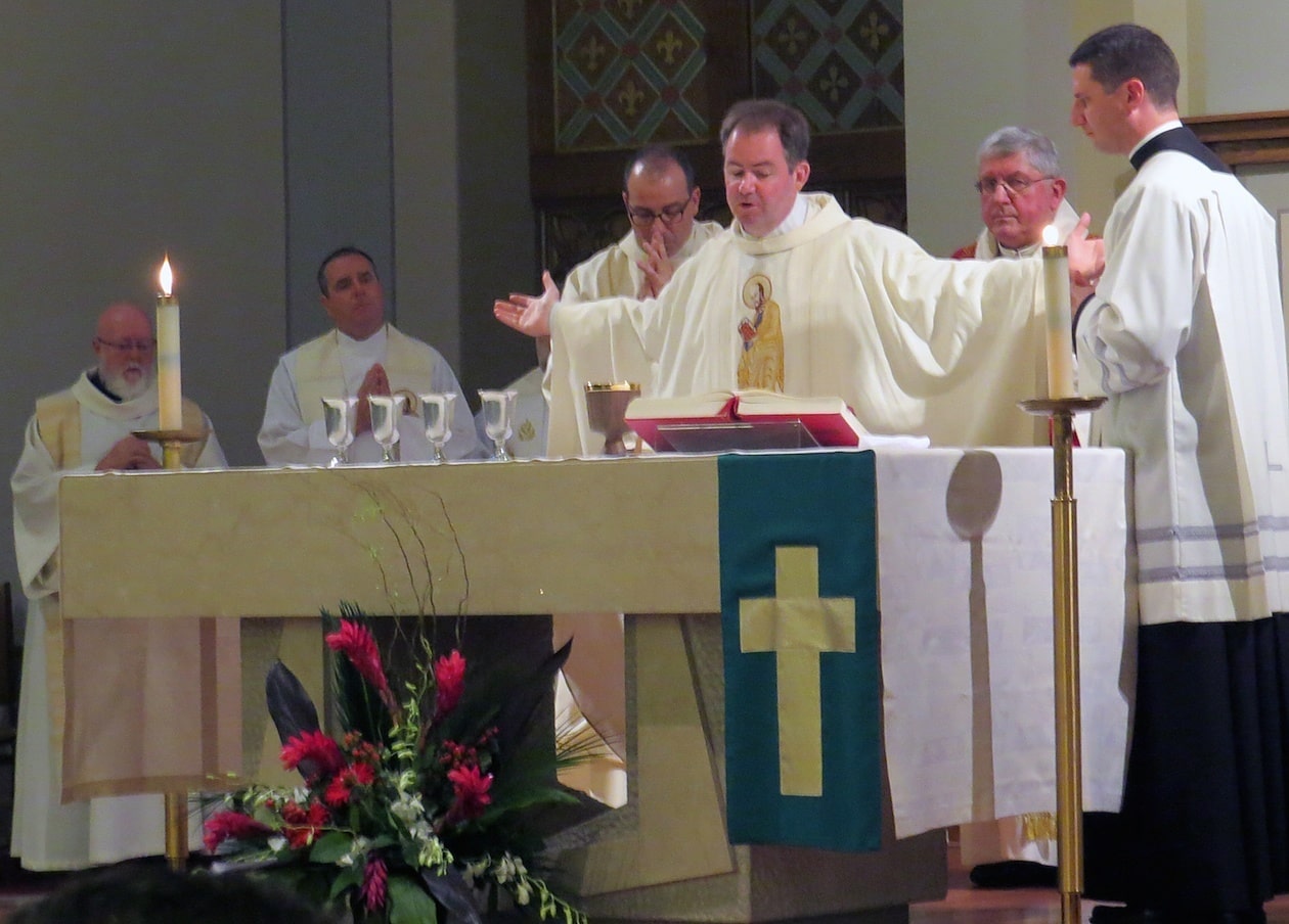 Father Tom Gibbons, CSP, administrator of St. Peter’s, says part of the Eucharistic Prayer.