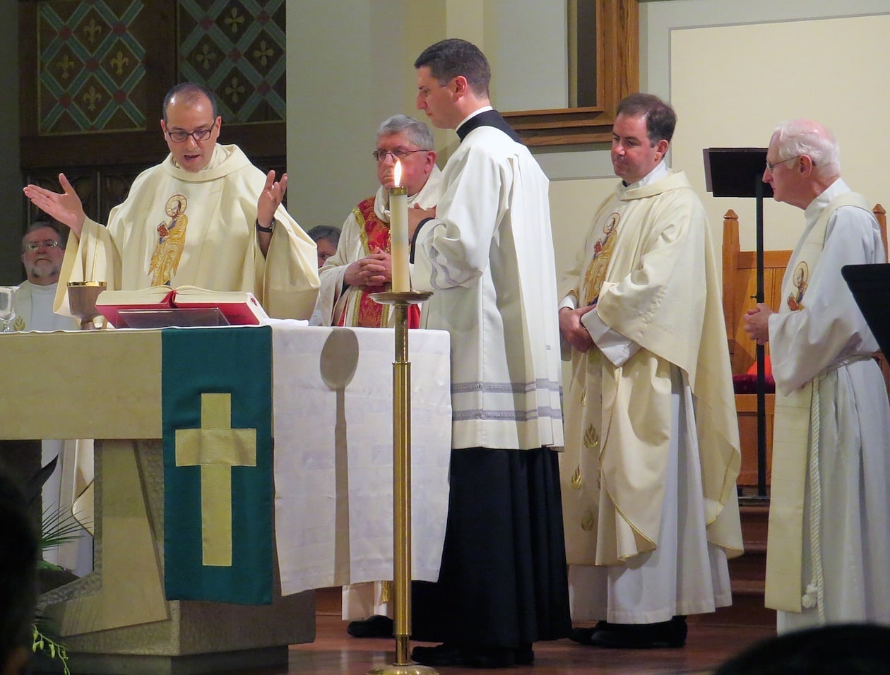 Father Eric Andrews, president of the Paulist Fathers, says part of the Eucharistic Prayer.