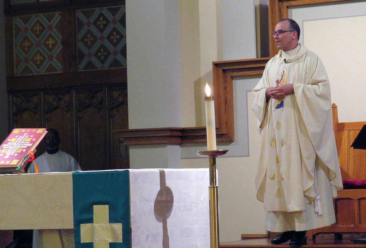 Father Eric Andrews, president of the Paulist Fathers, welcomes the congregants to Mass.
