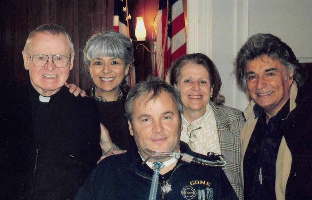 Paulist Fr. Kevin Devine (left) with members of Steven McDonald's prayer group.