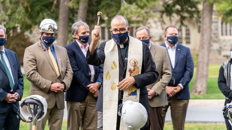 Fr. Eric Andrews, CSP blesses the ground of the site of Paulist House of Mission and Studies